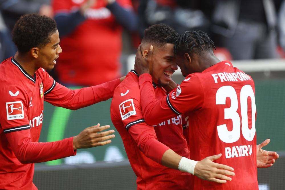 Bayer Leverkusen’s Paulinho celebrates scoring their fourth goal with Jeremie during the match against Schalke at the Bay Arena Stadium in Leverkusen, Germany, October 8, 2022. — Reuters pic