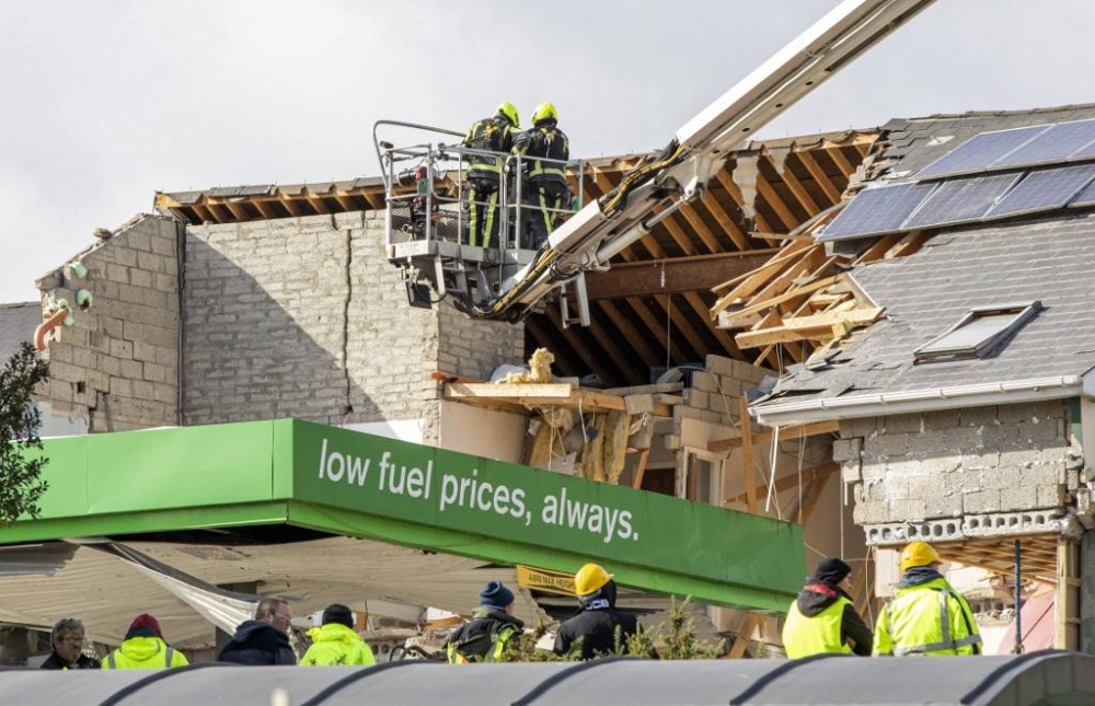 Emergency services attend the scene following an explosion in Creeslough, in the north west of Ireland on October 8, 2022. At least nine people have been killed in an explosion at a petrol station in County Donegal in Ireland's northwest, police said on Saturday. — AFP pic