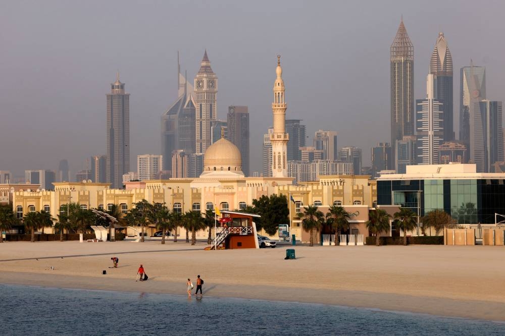People gather at a beach in the Gulf emirate of Dubai September 14, 2022. With deluxe match packages selling for thousands of dollars and five-star hotels doing a brisk trade, a sheen of glamour coats Qatar's World Cup despite football's working-class roots. — AFP pic