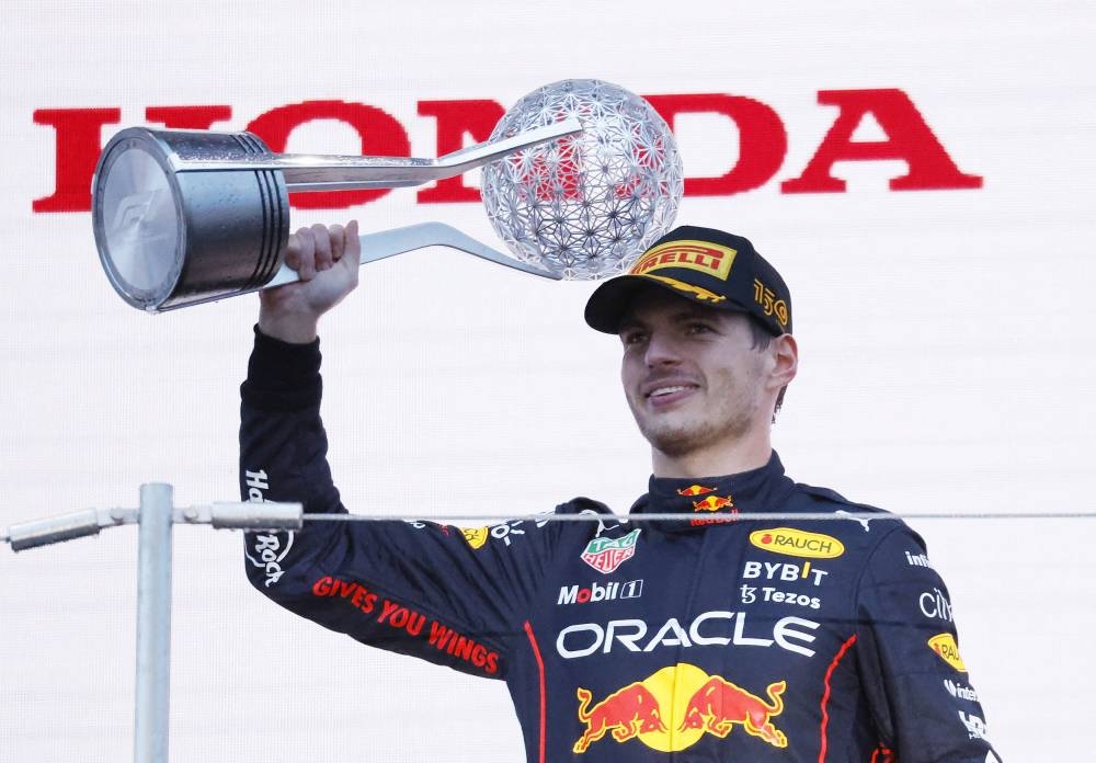 Red Bull's Max Verstappen celebrates winning the race and the championship on the podium of the Japanese Grand Prix Suzuka Circuit, Suzuka, Japan October 9, 2022. — Reuters pic