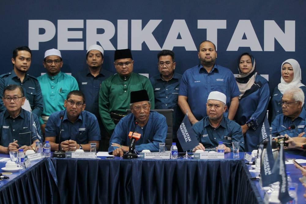 Perikatan Nasional (PN) chairman Tan Sri Muhyiddin Yassin (seated, centre) speaks during a press conference after chairing a Perak PN meeting in Ipoh October 9, 2022. — Bernama pic