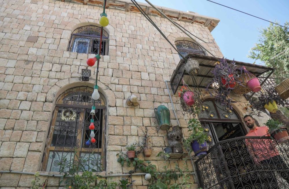 A man stands on the balcony of a stone building in the Kurdish town of Akre, 500 kilometres north of Iraq's capital Baghdad, on September 14, 2022. — AFP pic