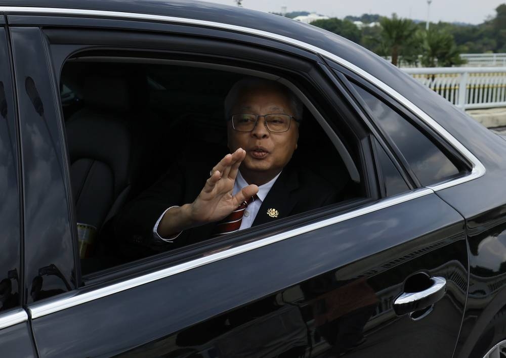 Prime Minister Datuk Seri Ismail Sabri Yaakob waves at reporters as he arrives at Putra Perdana for a special address, in Putrajaya October 10, 2022. — Bernama pic