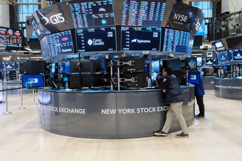 Traders work on the floor of the New York Stock Exchange (NYSE) on October 7, 2022 in New York City. Stocks fell in early trading on Friday as new employment numbers show steady hiring which investors fear will lead to increased interest rate hikes. — Spencer Platt/Getty Images/AFP pic