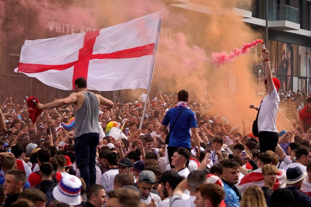 England fans cheer on their team outside Wembley Stadium ahead of the Uefa Euro 2020 final football match between England and Italy in north-west London July 11, 2021. — AFP pic