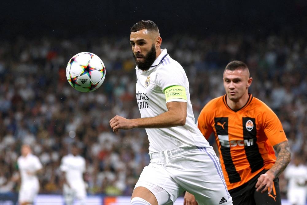 Real Madrid's Karim Benzema in action with Shakhtar Donetsk's Oleksandr Zubkov at the Santiago Bernabeu, Madrid October 5, 2022. — Reuters pic