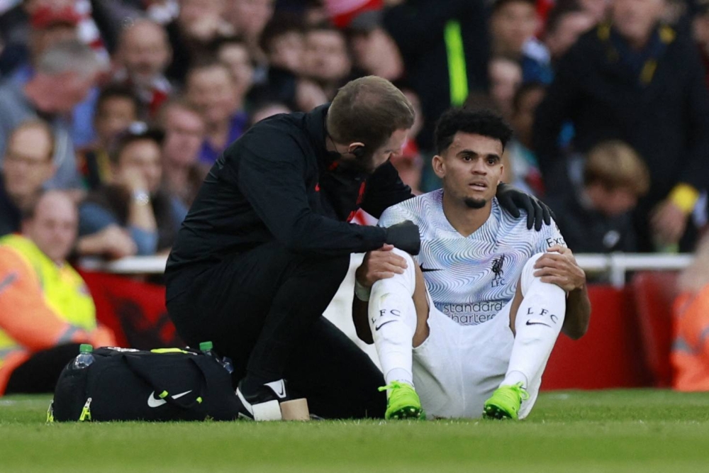 Liverpool's Luis Diaz receives medical attention after sustaining an injury against Arsenal at the Emirates Stadium, London October 9, 2022. — Reuters pic