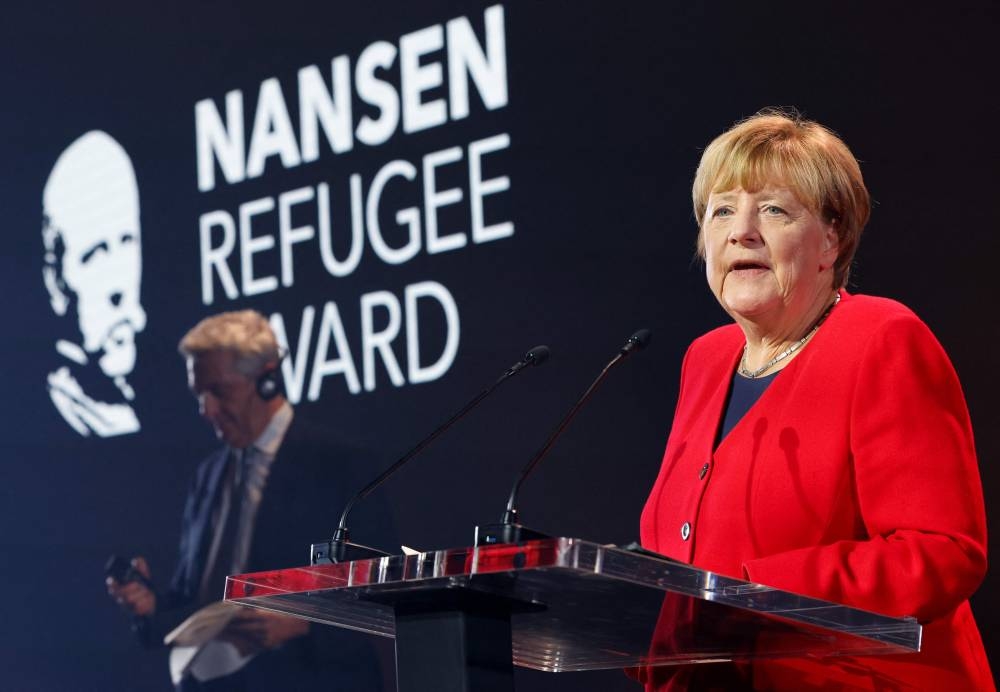 Germany's former chancellor Angela Merkel delivers a speech during a ceremony to receive the UNHCR Nansen Refugee Award for protecting refugees at height of Syria crisis, in Geneva October 10, 2022. ― AFP pic