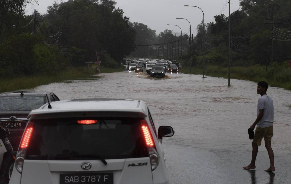 Motorists are seen trapped on a flooded road in Kota Kinabalu October 9, 2022. — Bernama pic
