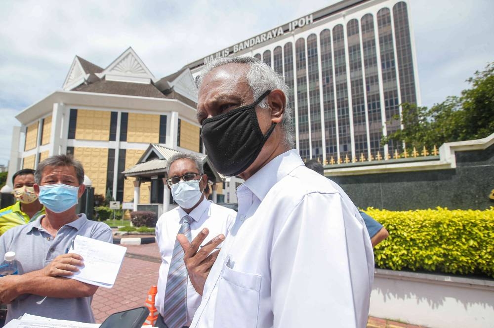 Parti Sosialis Malaysia chairman Dr Jeyakumar Devaraj speaks to reporters outside the Ipoh City Council April 1, 2021. — Picture by Farhan Najib 