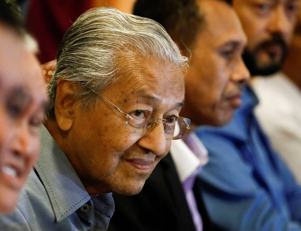 Tun Dr Mahathir Mohamad attends a news conference at Putrajaya October 11, 2022. — Reuters pic
