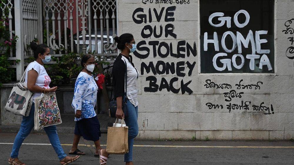 People walk past a graffiti-filled wall in Sri Lanka. International Monetary Fund and World Bank have held meetings in Washington this week amid rising global recession worries and a crop of debt crises from Sri Lanka and Pakistan to Chad, Ethiopia and Zambia. — AFP file pic
