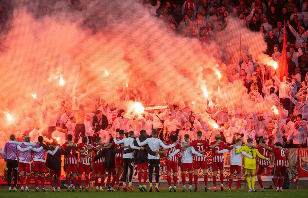 Union Berlin players celebrate their victory with fans after the Uefa Europa League group D football match against Malmo FF in Malmo, Sweden October 6, 2022. — AFP pic