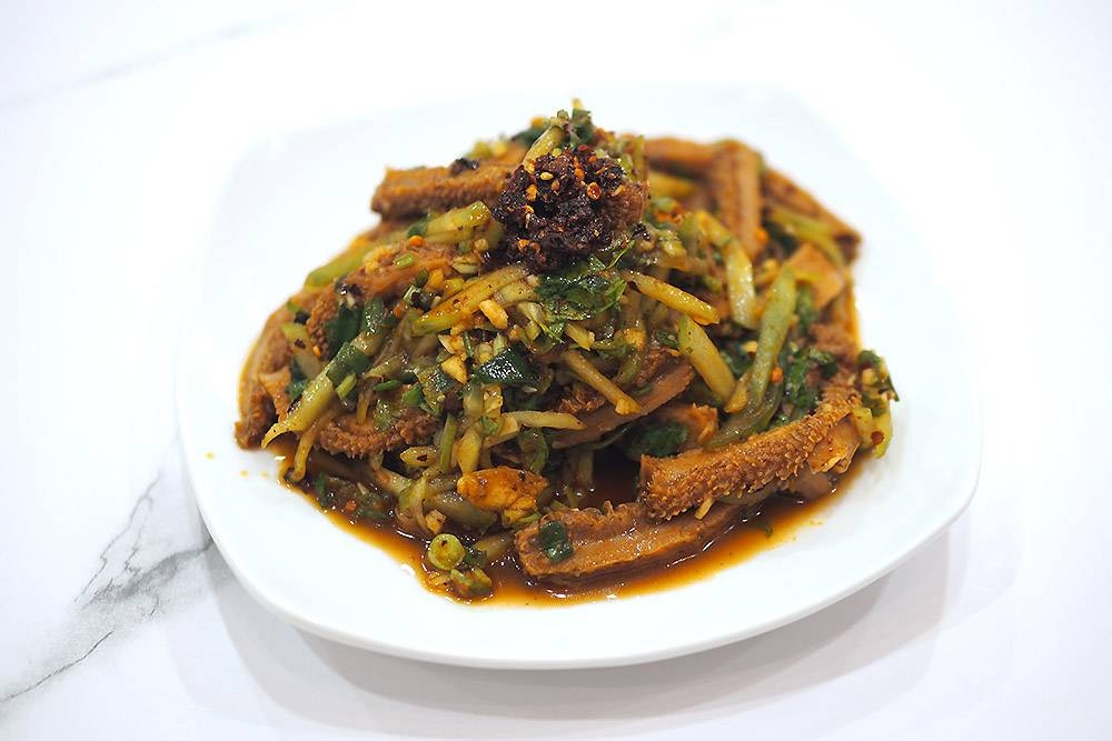 There's various side dishes like cold salads, a nod towards the north-east China roots, like this unusual cold tripe salad.
