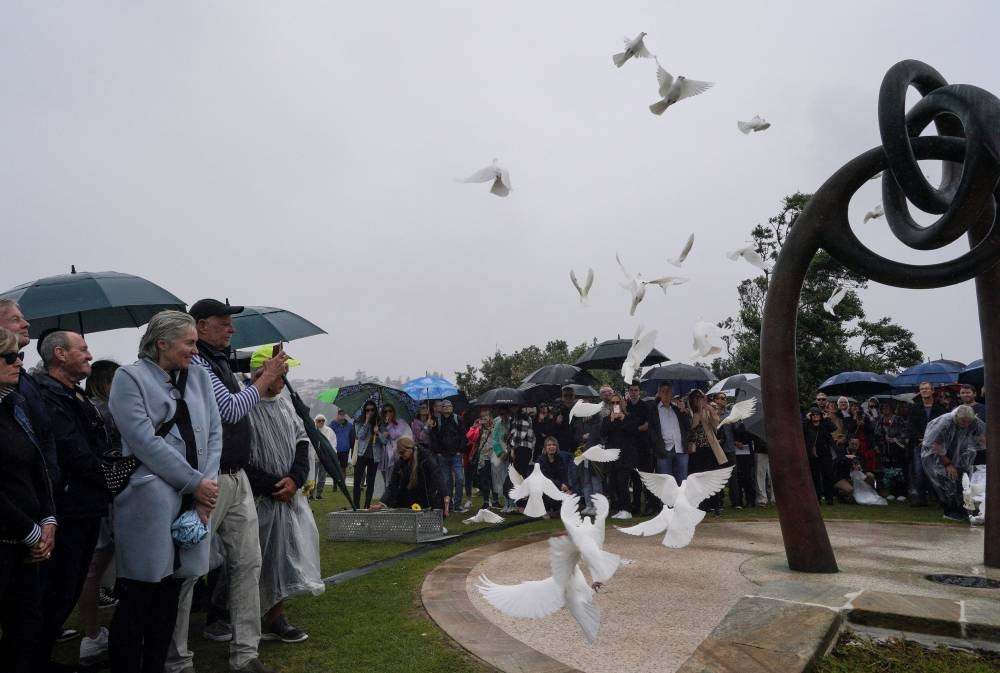 Doves are released during a memorial service to mark the 20th anniversary of the Bali bombings, which killed 202 people including 88 Australians, at Coogee Beach in Sydney, Australia, October 12, 2022. ― Reuters pic