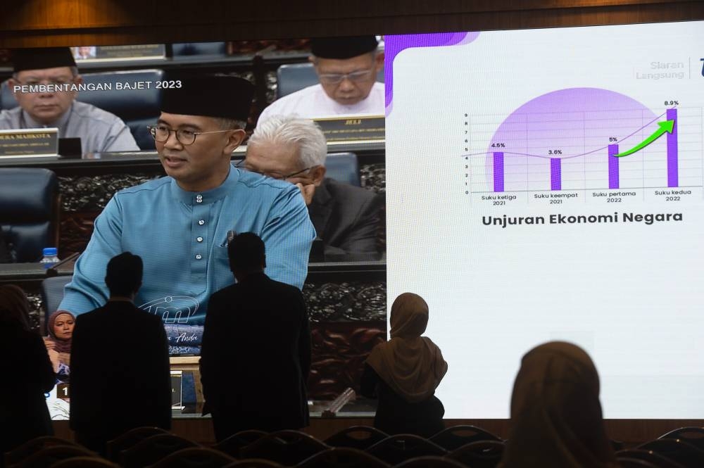 Government servants watch Finance Minister Datuk Seri Tengku Zafrul Abdul Aziz speaking during the tabling of Budget 2023 in the Dewan Rakyat, October 7, 2022. — Picture by Shafwan Zaidon