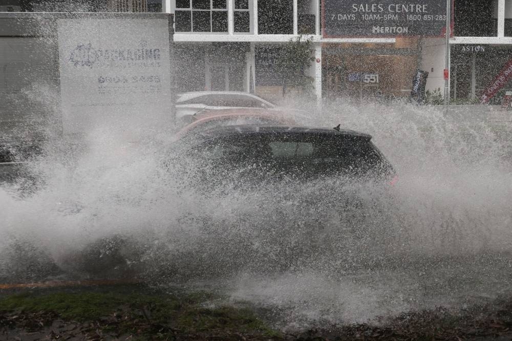 Vehicles drive through floodwaters as heavy rains affect Sydney, Australia, October 6, 2022. — Reuters pic