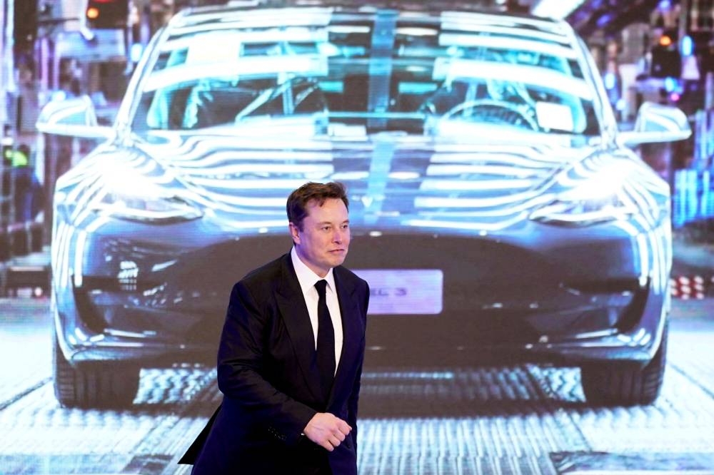 Tesla Inc CEO Elon Musk walks next to a screen showing an image of Tesla Model 3 car during an opening ceremony for Tesla China-made Model Y program in Shanghai January 7, 2020. — Reuters pic