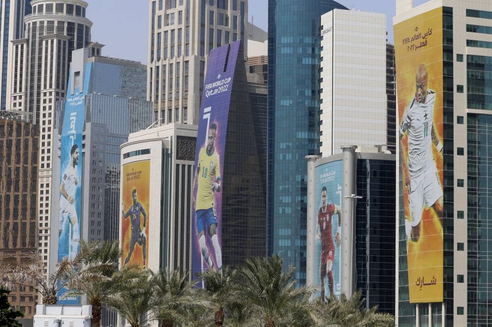 Fifa 2022 World Cup branding and images of players are seen on buildings in Doha October 12, 2022. — Reuters pic