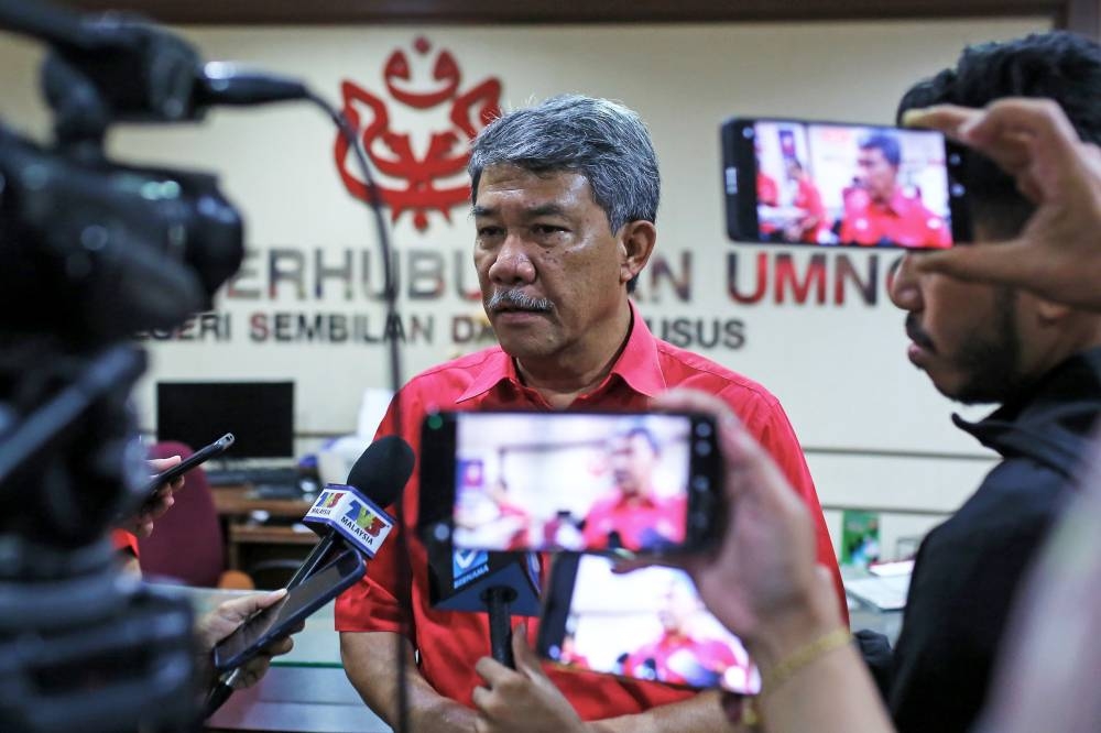 Umno deputy president Datuk Seri Mohamad Hasan (centre) speaks to the media after the Negri Sembilan Umno liaison committee meeting in Seremban October 14, 2022. — Bernama pic