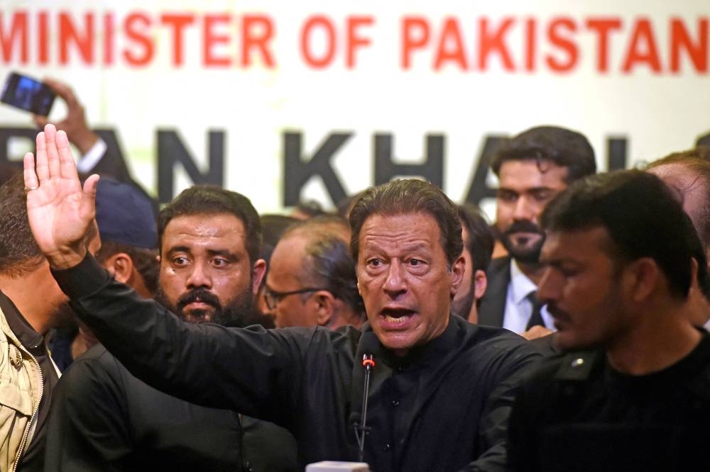 Pakistan’s former Prime Minister Imran Khan (centre) speaks at an event of Karachi Bar Association in Karachi on October 14, 2022. ― AFP pic