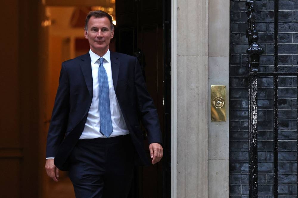 Britain’s new Chancellor of the Exchequer Jeremy Hunt leaves 10 Downing Street in central London on October 14, 2022, after having a meeting with Britain’s Prime Minister Liz Truss. ― AFP pic