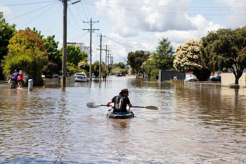 A local resident paddles through a flooded street in Shepparton, Victoria, Sunday, October 16, 2022. The flooding crisis has worsened in Victoria's north with residents told to move to higher ground. — AAP Image via Reuters