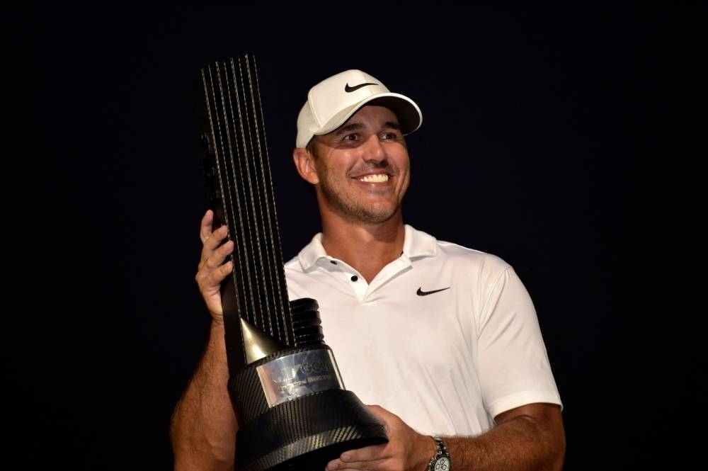 US golfer Brooks Koepka poses with his trophy following his play-off win in the LIV Golf Invitational-Jeddah at the Royal Greens Golf Club on October 16, 2022. — Reuters pic