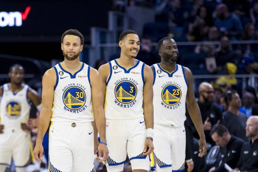 Golden State Warriors guard Jordan Poole (3) and guard Stephen Curry (30) and forward Draymond Green (23) re-enter the court after a time-out during the first half of the game against the Denver Nuggets at Chase Centre in San Francisco October 14, 2022. — Reuters pic