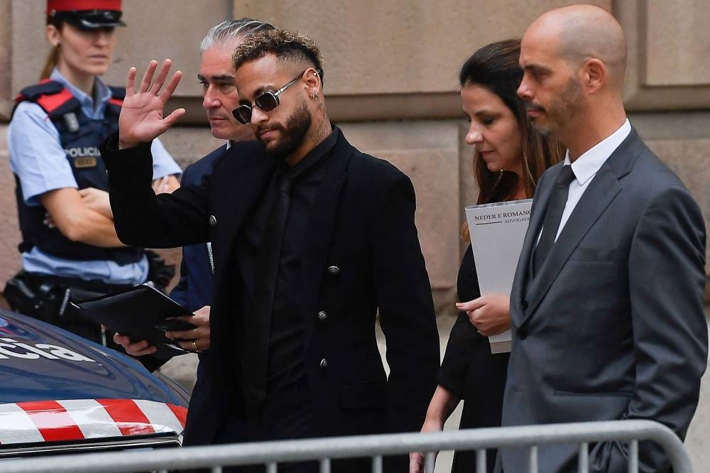 Paris Saint-Germain forward Neymar gestures as he arrives at the courthouse in Barcelona October 17, 2022, on the first day of his trial. — AFP pic 