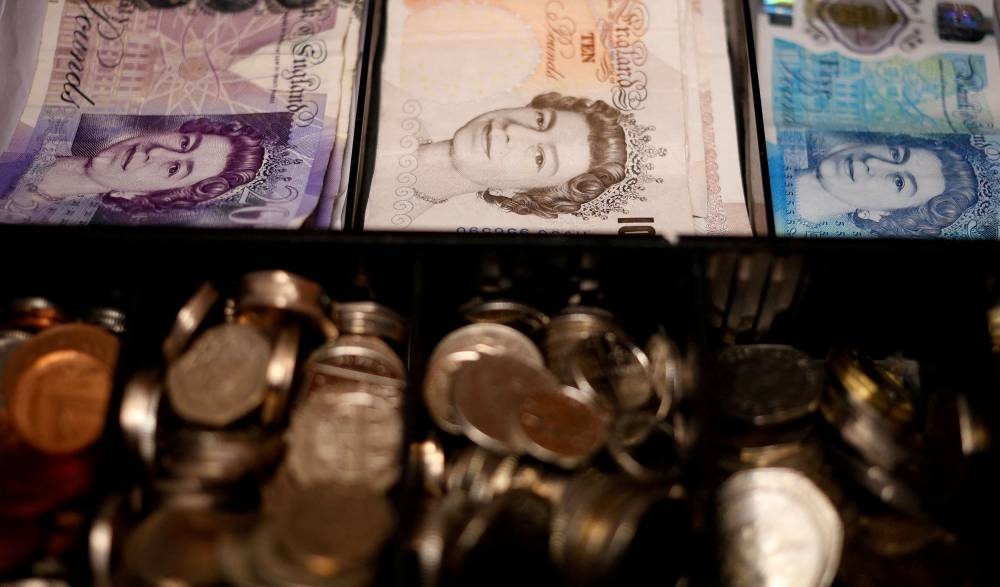 Pound notes and coins are seen inside a cash register in a bar in Manchester September 6, 2017. — Reuters pic