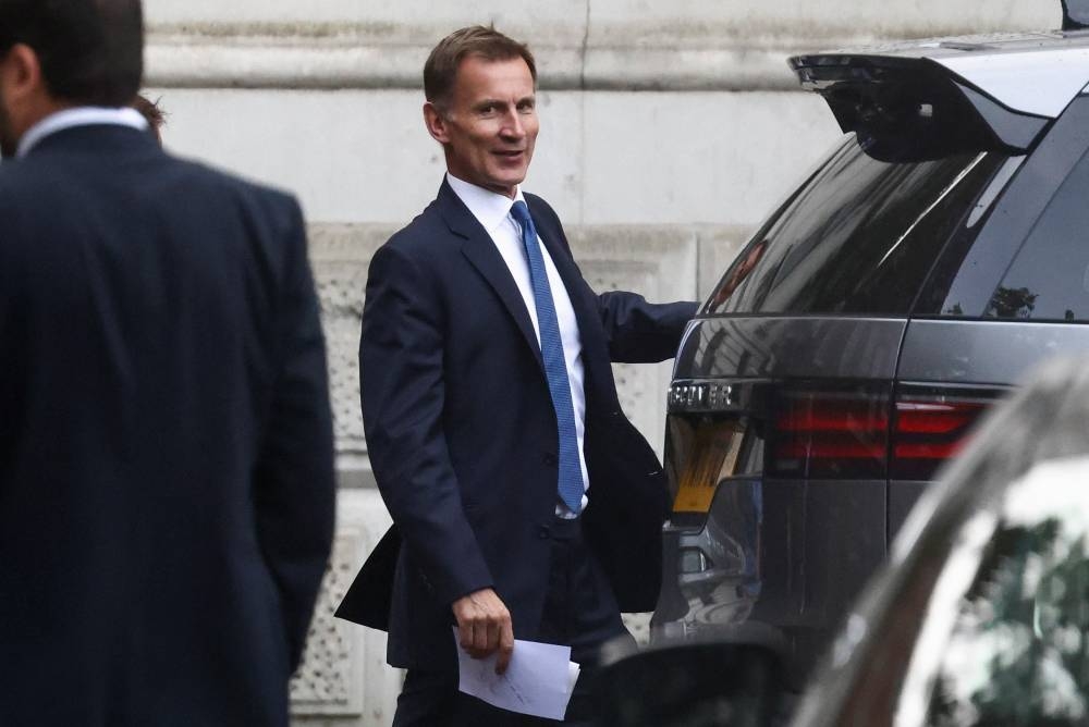 British Chancellor of the Exchequer Jeremy Hunt walks outside Downing Street in London October 17, 2022. — Reuters pic