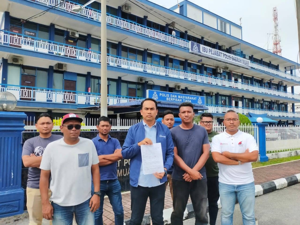 Muar Umno Youth chief Mohd Helmy Abd Latif (centre) after lodging a police report at the Muar district police headquarters in Muar October 17, 2022. — Picture courtesy of Muar Umno Youth