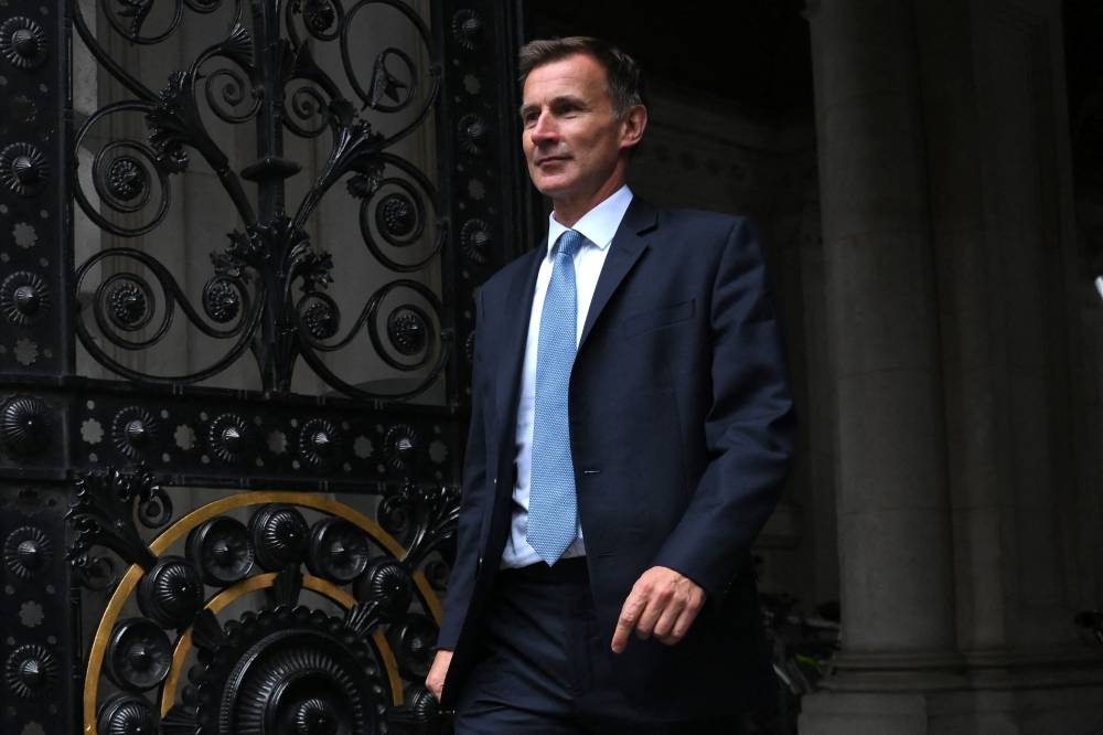 Britain's new Chancellor of the Exchequer Jeremy Hunt arrives in Downing Street in central London on October 14, 2022. — AFP pic