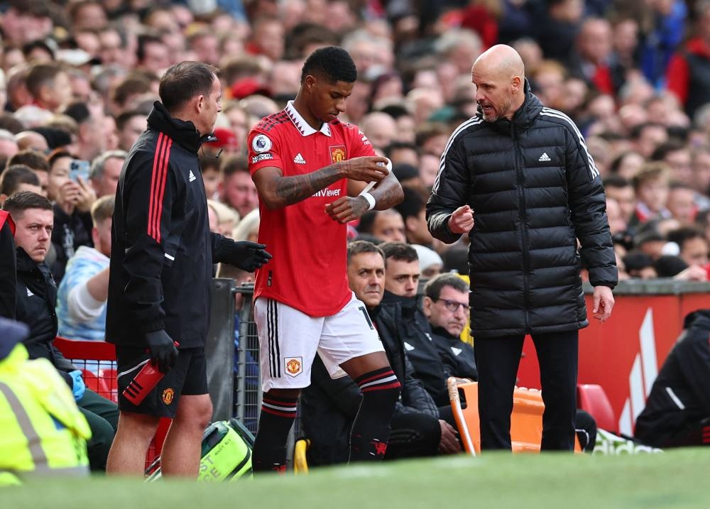 Manchester United's Marcus Rashford with manager Erik ten Hag before he comes on as a substitute against Newcastle United at Old Trafford, Manchester October 16, 2022. — Reuters pic	