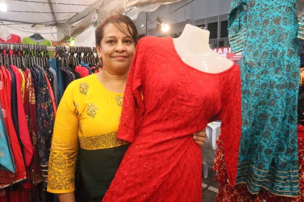 Saravanan (middle) with his family who are running the business at Thilagesh Centre explained that the business prides itself for its tailoring, clothes alteration and custom made lenghas.