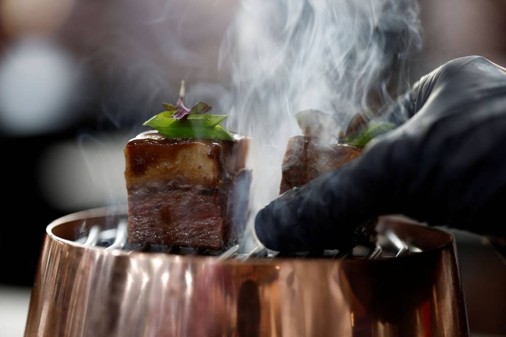 A chef arranges a dish containing 3D printed plant-based vegan meat, produced by Israeli start-up Redefine Meat at SIAL food and innovation exhibition in Villepinte, near Paris October 19, 2022. — Reuters pic