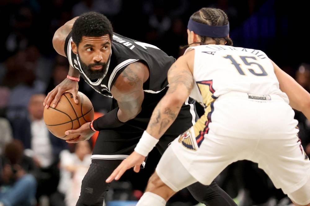 Brooklyn Nets guard Kyrie Irving (11) controls the ball against New Orleans Pelicans guard Jose Alvarado (15) during the first quarter at Barclays Centre in Brooklyn October 19, 2022. — Reuters pic