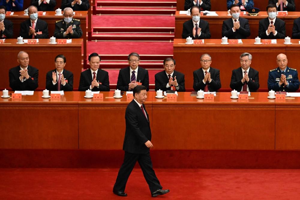 China's President Xi Jinping (centre) arrives for the opening session of the 20th Chinese Communist Party's Congress at the Great Hall of the People in Beijing on October 16, 2022. — AFP pic