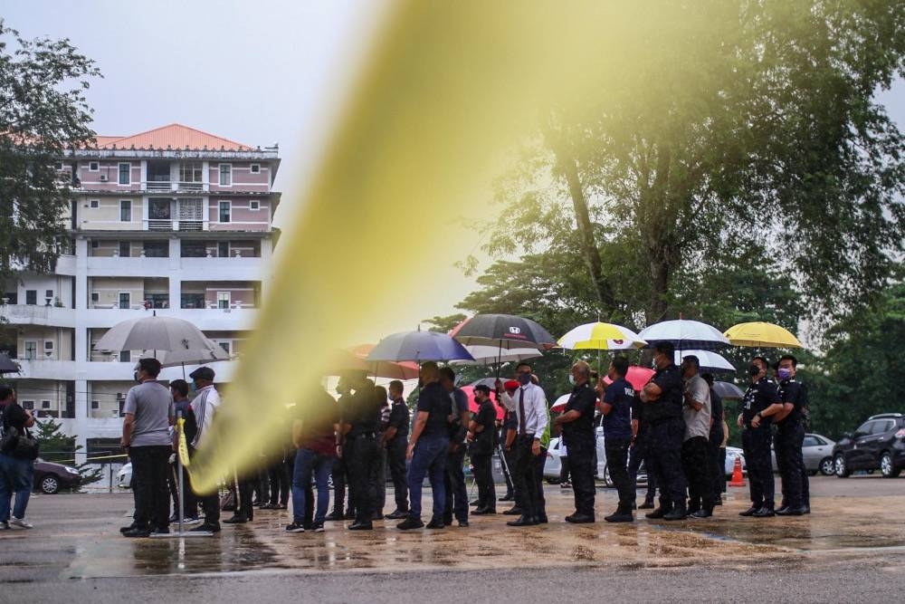 File picture shows personnel from the Malaysian Armed Forces, police, the General Operations Force including their spouses, voting in the rain during the early polling of the Johor state election, March 8, 2022. — Picture by Hari Anggara