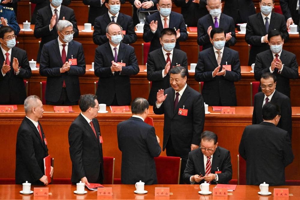 China’s President Xi Jinping (centre) gestures during the closing ceremony of the 20th Chinese Communist Party’s Congress at the Great Hall of the People in Beijing on October 22, 2022. — AFP pic