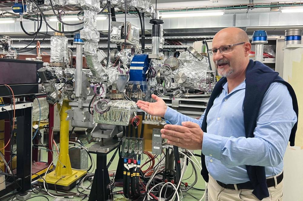 CERN Linear Electron Accelerator for Research (CLEAR) Lab facility coordinator Roberto Corsini gestures next to a 40-metre linear particle accelerator at the European Organization for Nuclear Research (CERN) in Meyrin, near Geneva on October 17, 2022. — AFP pic