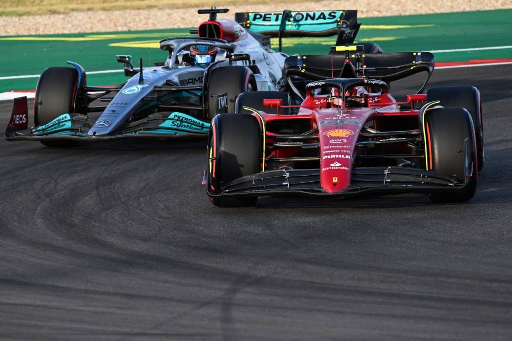 Ferrari's Spanish driver Carlos Sainz Jr and Mercedes' British driver George Russell (L) make a turn during the qualifying session for the Formula One United States Grand Prix, at the Circuit of the Americas in Austin, Texas, on October 22, 2022. — AFP pic