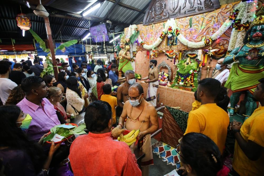 Hindu devotees offer a prayer during Deepavali festival at Sri Kandaswamy Temple in Brickfields October 24, 2022. — Picture by Ahmad Zamzahuri