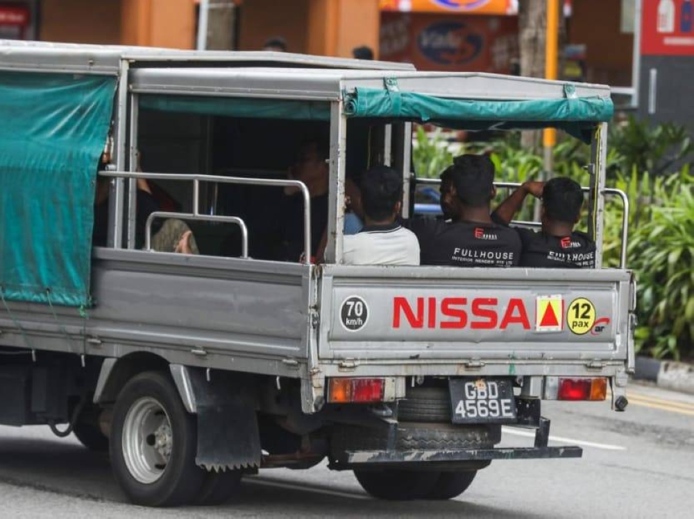 Workers being transported on the back of a lorry on October 22, 2022. ― TODAY pic