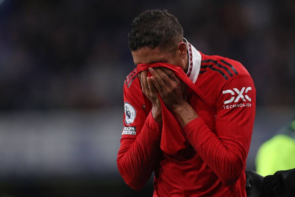 Manchester United’s French defender Raphael Varane reacts as he leaves the pitch after picking up an injury during the match between Chelsea and Manchester United at Stamford Bridge in London, October 22, 2022. — AFP pic 