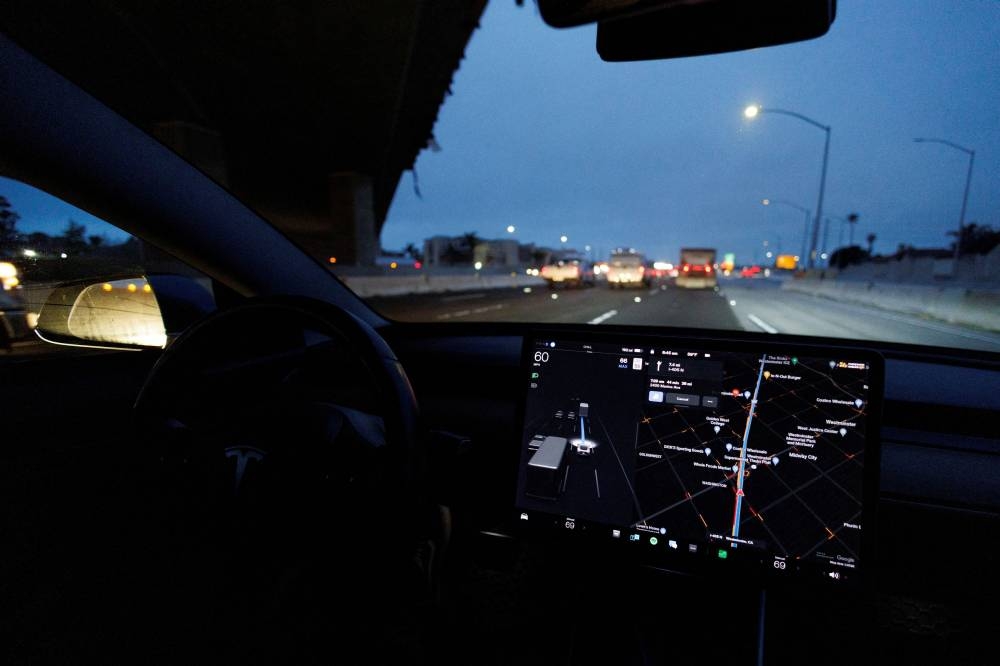 A Tesla Model 3 vehicle drives on autopilot along the 405 highway in Westminster, California March 16, 2022. — Reuters pic