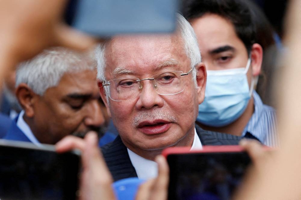 Datuk Seri Najib Razak speaks to reporters outside the Federal Court during a court break in Putrajaya August 23, 2022. — Reuters pic