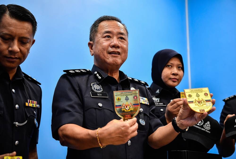 Sentul District police chief ACP Beh Eng Lai with the logos used by the syndicate during a press conference at the Sentul District Police Headquarters, October 27, 2022. — Bernama pic 