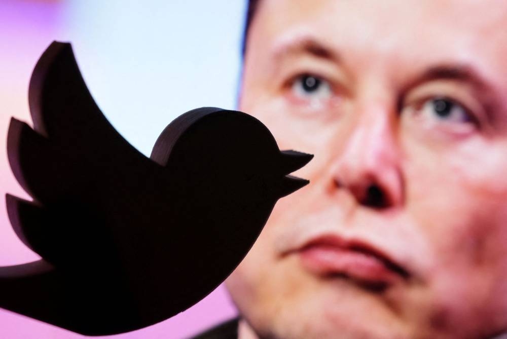 A 3D printed Twitter logo is seen in front of a displayed photo of Elon Musk in this illustration taken October 27, 2022. — Reuters pic